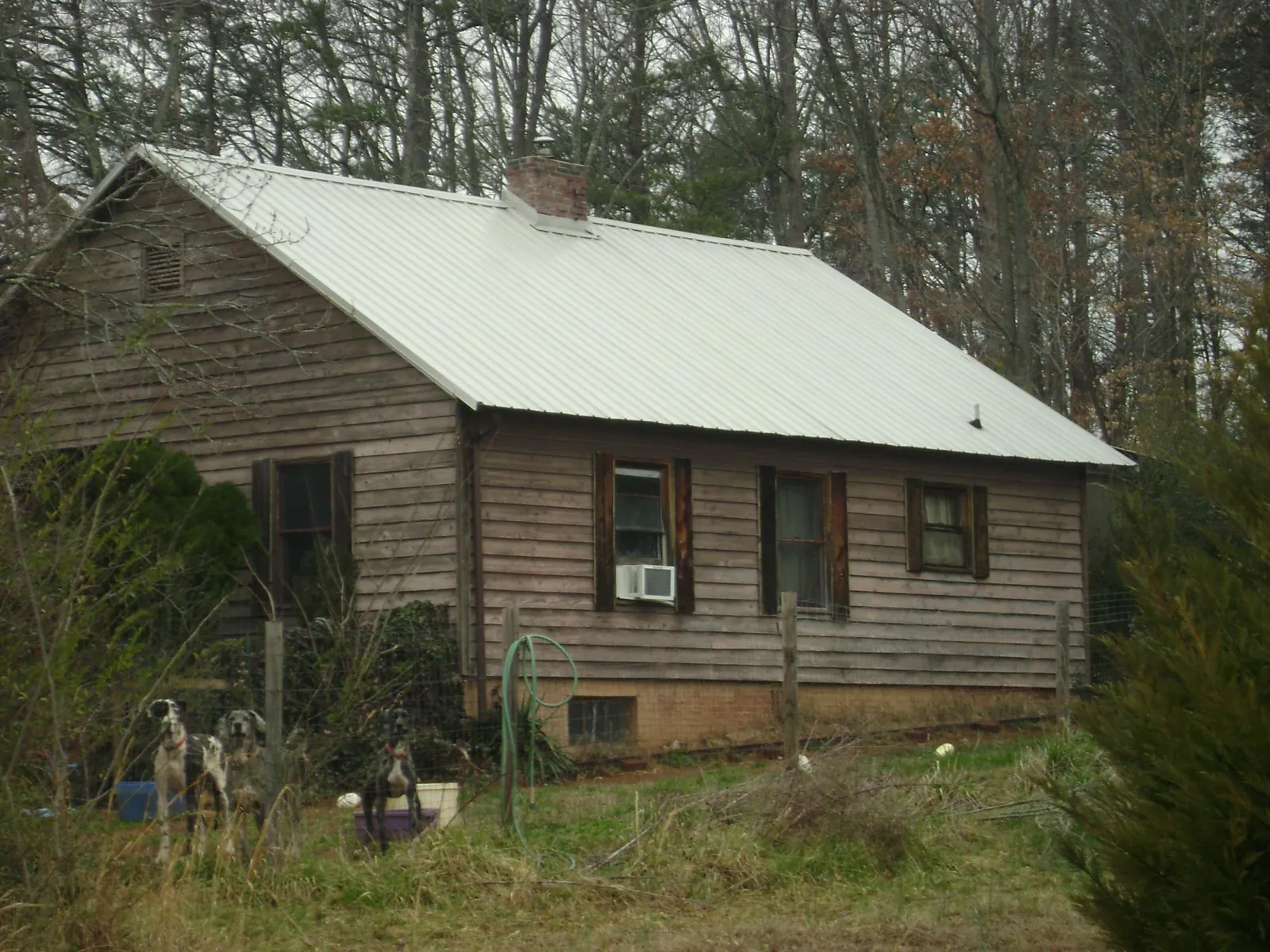 White metal roof on an old wood sided farmhouse, from a Metal Roof Installation job in Gwynn Oak
